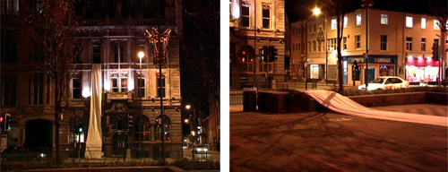 2 video stills: Images show a very long piece of what fabric as it travels out of the 3rd story window of a building onto the street below; then moves over ground accross Leeds' Victoria Gardens.