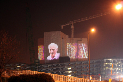 image shows 3 projections onto the outside of a large apartment block in Bristol